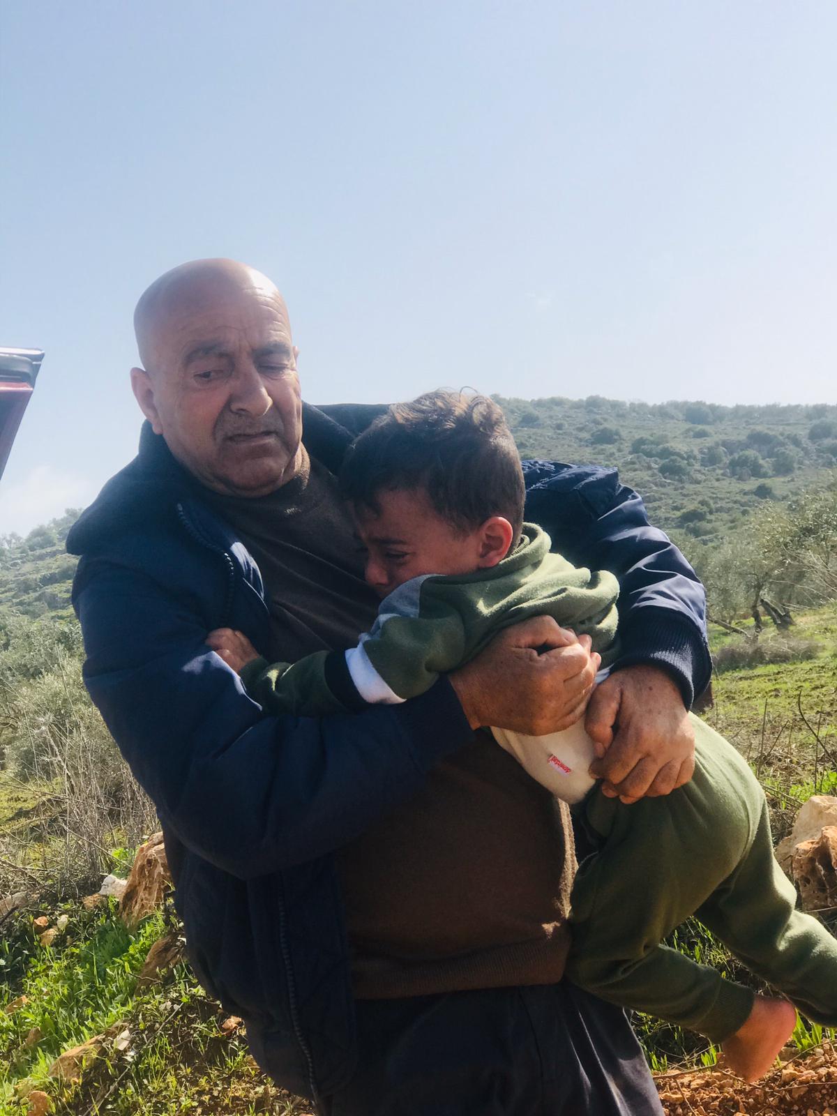 Musa Abu ‘Awwad with one of his grandsons. Photo by Iyad Hadad, B'Tselem