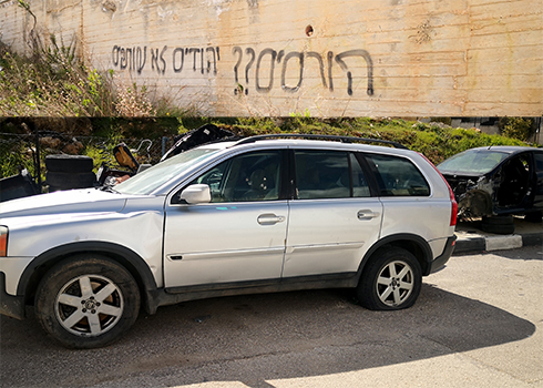 The slogan “Demolitions?? Jews don’t remain silent” sprayed by settlers, and one of the vandalized cars. Photo courtesy of neighborhood residents 