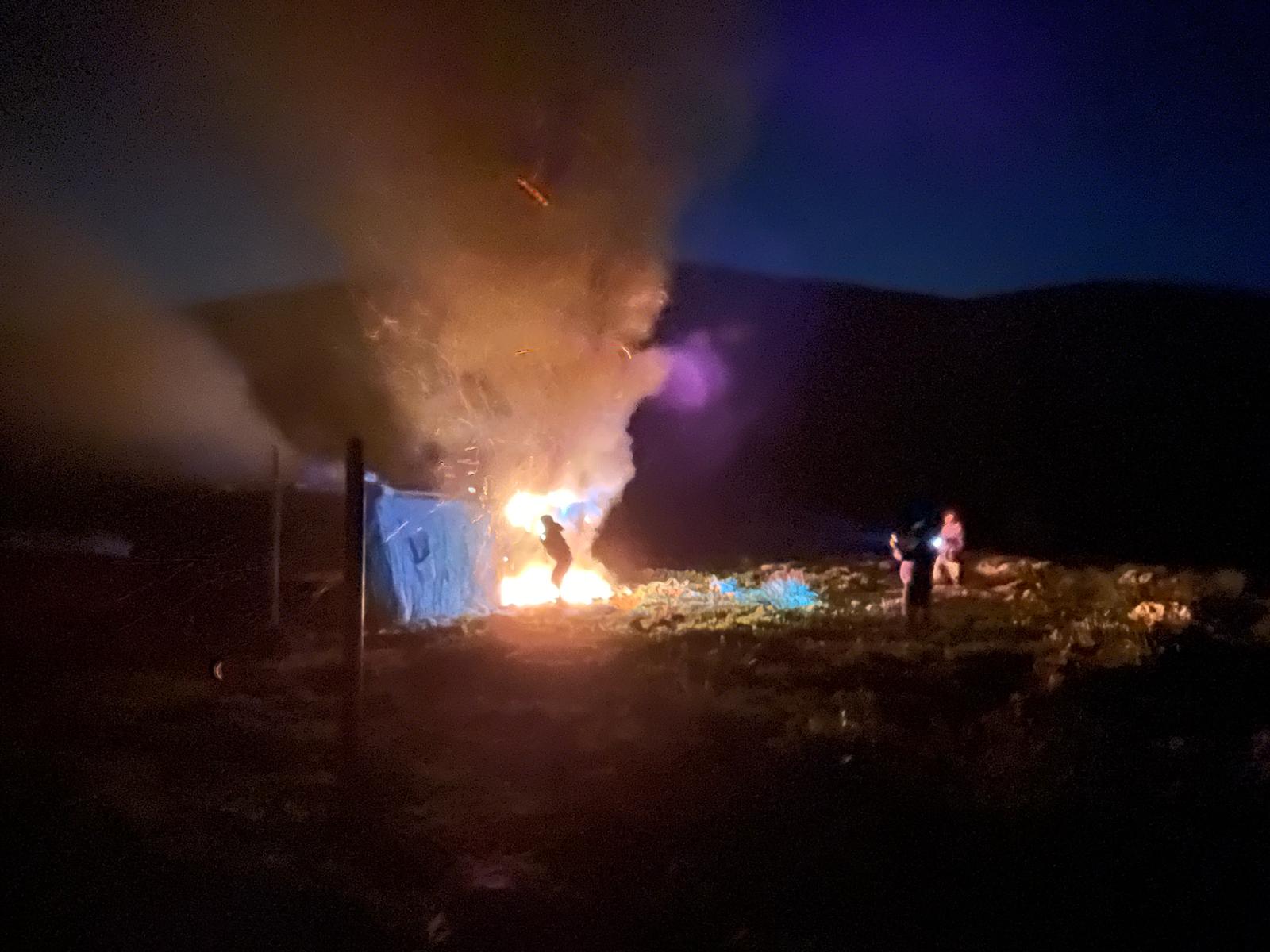 Settlers setting fire to the empty livestock enclosure on 12 February 2026. Photo courtesy of Jordan Valley activists 