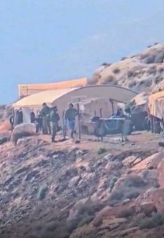 Israeli soldiers and settlers in the community. Photo courtesy of the residents
