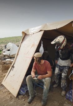 The settlers in the family’s tent. Still from video footage courtesy of Jordan Valley activists 