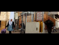 Palestinian children on their way to school going through Checkpoint 160, Hebron city center. Photo by Mussa Qawasma, Reuters, 3 May 2019