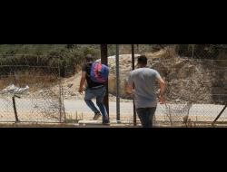 Palestinian laborers cross through gap in Separation Barrier near Far'on, in the are of Qalqilya. Photo by Alex Levac, 6 June 2020