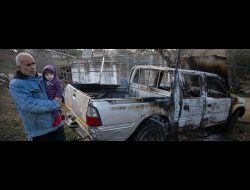 Suliman Muhammad Fuqaha next to his car, which was set on fire by settlers who attacked the village of Sinjil in Ramallah District. Photo by Avishay Mohar, B'Tselem, 20 Jan. 2025