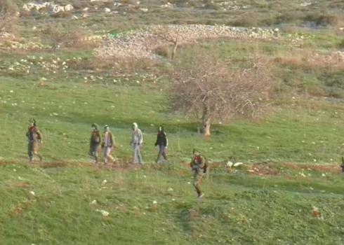 Settlers escorted by soldiers on their way to attack the ‘Abd al-Bassett family home. ‘Asirah al-Qibliyah, 6 Feb. 2021. Photo by Ibrahim Makhluf