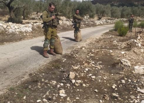 Soldiers with the olive sacks they took from the farmers. Photo courtesy of the Shteiwi family 