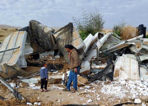 Two members of the family that lost its home near its ruins. Photo: 'Aref Daraghmeh, B'Tselem, 13 Feb. 2023 