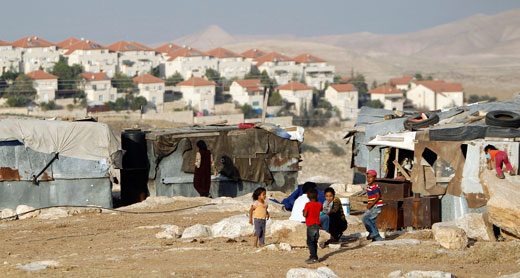 Children of the Jahalin tribe. Israel plans to expel the area’s Bedouin villagers to expand the settlement of Ma’ale Adumim (background). Photo: ‘Amer ‘Awad, Reuters, 16 June 2012