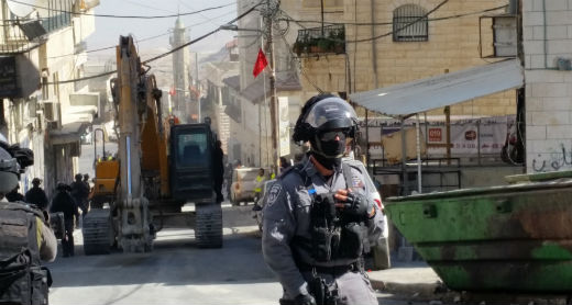 Jerusalem Municipality bulldozer en route to demolish a home in al-‘Esawiyah, East Jerusalem. Photo by Hussam ‘Abed, B’Tselem, 8 Nov. 2016