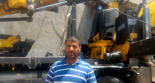 Sarhan Hamed by one of his trucks. Photo by Iyad Hadad, B’Tselem, 3 May 2017 